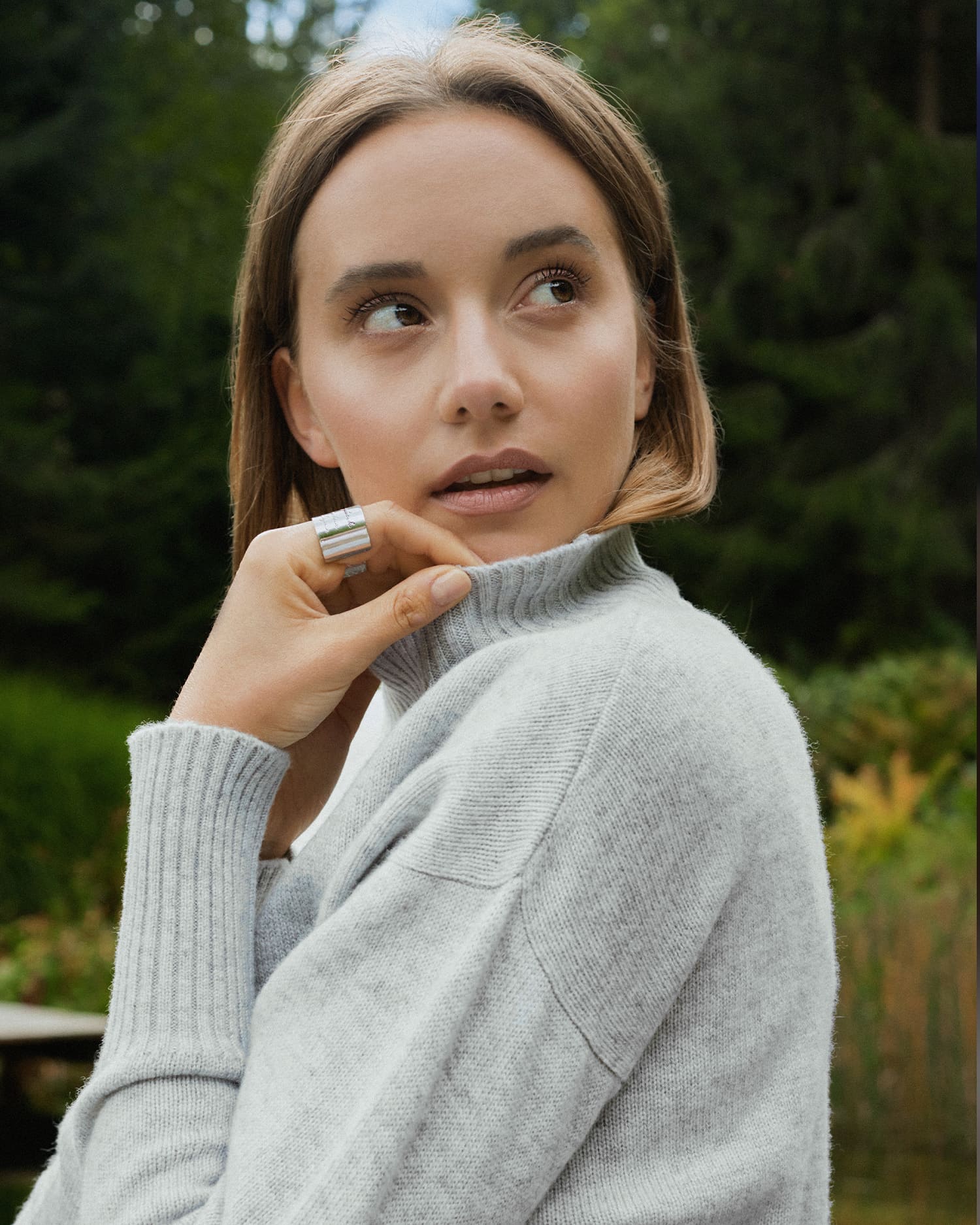 Man and woman wear cashmere clothing in various shades of beige.